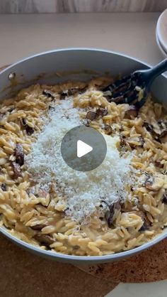 a pan filled with pasta and cheese on top of a table