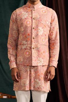 Rose bundi with floral print. Comes with shirt style kurta in floral printed motifs and mandarin collar. Paired with pyjama.
Component: 3
Pattern: Printed
Type Of Work: Floral
Neckline: Band
Sleeve Type: Cuff
Fabric: Malai Cotton
Color: Pink
Other Details: 
Closure: Front buttons
Occasion: Destination Wedding - Aza Fashions Festive Long Sleeve Bandhgala With Floral Print, Designer Floral Print Long Sleeve Sherwani, Designer Long Sleeve Floral Print Sherwani, Traditional Nehru Jacket With Floral Print, Semi-formal Long Sleeve Nehru Jacket For Spring, Traditional Floral Print Bandhgala For Spring, Traditional Nehru Jacket With Floral Print For Designer Wear, Traditional Spring Bandhgala With Floral Print, Traditional Formal Sets With Floral Print