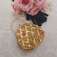 "Hand made vintage gold evening bag with golden beads & golden sequins. Gold-tone chain wrist strap. Small golden beads in a diamond pattern with smaller golden sequins in the diamond shapes and larger golden sequins between the diamonds. Tuck the gold-tone metal chain inside and convert to an evening clutch! Kiss lock at the top with two rhinestones. Gold tone metal bracket. Lined with yellow sateen and a handy pocket on one side. A small evening bag that hangs from the wrist or fingertips or c Gold Sequined Bags For Party, Gold Sequined Party Bag, Gold Sequin Party Bag, Gold Party Bags With Sequins, Gold Sequin Bags For Gifts, Gold Sequined Bags For Gifts, Gold Sequined Bags As Gifts, Gold Sequined Evening Bag For Parties, Gold Sequin Clutch Bag