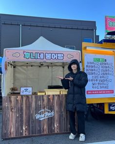 a man standing in front of a food cart