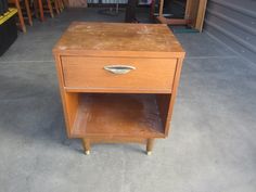 a small wooden table with a drawer on it