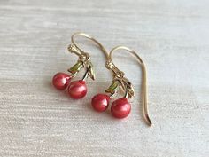 These dainty and cute cherry earrings are made of the following: (1) Gold plated red and green enamel cherry charm (12 x 10mm) (2) Gold plated or 14KGF earring hooks ✏️ Please choose your desired earring hooks 🍒EARRINGS 🍒 Clip On Hoops → https://www.etsy.com/listing/905698702 Threader -> https://www.etsy.com/listing/602107194 🍒NECKLACE 🍒 -> https://www.etsy.com/listing/615948435 【ADDITIONAL QUANTITY】 Kindly convo us if you require additional quantity and we will be happy to customize t Cute Red Enamel Earrings, Cute Cherry Dangle Jewelry, Sweet Red Earrings For Gift, Nickel Free Cherry Colored Earrings For Gift, Nickel Free Cherry Earrings For Gift, Nickel-free Cherry Colored Earrings For Gift, Cherry Jewelry, Jewelry Kawaii, Cherry Charm