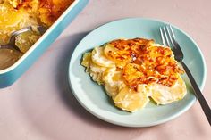 a blue plate topped with food next to a casserole dish