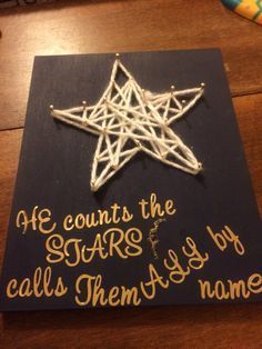 a string art star on top of a wooden table