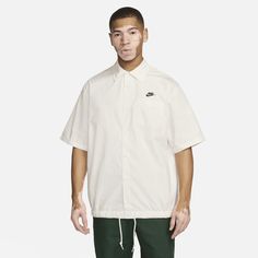 Made from smooth woven cotton in an easygoing button-down design, this summer-ready top from our Nike Club collection gives you versatility for days. The roomy fit and drawcord hem let you style it how you like it—button it up for business or let it hang open for casual, free-flowing style. Casual Cotton Camp Shirt For Streetwear, Nike Short Sleeve Relaxed Fit Shirt, Nike Relaxed Fit Short Sleeve Shirt, White Cotton Camp Shirt For Streetwear, Nike Cotton Collared Tops, Nike Casual Collared Shirt, Casual Nike Collared Shirt, White Camp Shirt For Spring Streetwear, Casual Relaxed Fit Camp Shirt For Daywear