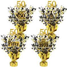 the 50th anniversary party decorations are gold and black with stars on them, as well as numbers