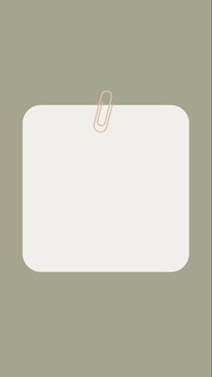 a white sign with a pink paper clip on it's side against a green background