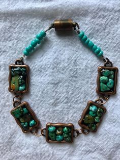 Antiqued copper bezels decorated with chalk turquoise chips, accented with teal glass beads. Great colors for summer, fall, or winter! The bracelet measures approximately 9" long and is finished with an antiqued copper magnetic barrel clasp. Green Bohemian Bracelets With Patina, Unique Turquoise Czech Glass Beaded Bracelets, Artisan Turquoise Czech Glass Bracelets, Artisan Turquoise Copper Bracelet, Unique Turquoise Czech Glass Bracelet, Beaded Bronze Copper Bracelets, Unique Turquoise Copper Bracelets, Bronze Beaded Copper Bracelets, Blue Bohemian Copper Bracelets