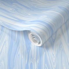 a roll of blue and white wall paper