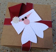 an origami santa clause on top of a brown box