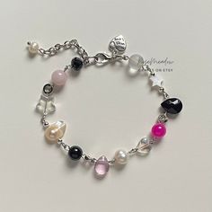 "Handmade Dreamy bracelet ✿ Made with freshwater pearls, Quartz, mother of pearl, glass crystal beads, glass beads, and metal accents ✿ Silver, petal pink, fascia, black, clear, clear mauve, pearlescent white, and iridescent clear ✿ The bracelet has an additional 1-1.5\" of extension chain. If you'd like a shorter or longer length, select your preferred length. Some beads may be added or removed." Black Pearl Bracelets As Gift, Black Pearl Bracelets For Gift, Black Pearl Bracelets For Gifts, Dreamy Bracelet, Mother Of Pearl Bracelet, Kiss Of Life