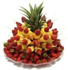 a pineapple and strawberries arrangement in a bowl