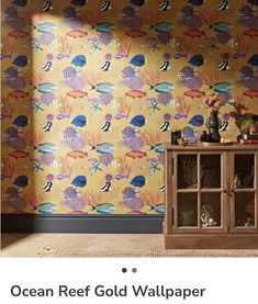 an ocean reef wallpaper with fish and corals on yellow background, next to a wooden cabinet