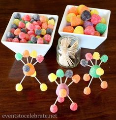 two white bowls filled with candy sitting on top of a wooden table