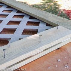 some screws are sticking out of the side of a wooden structure that is being built