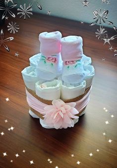 two baby booties sitting on top of a wooden table next to stars and snowflakes