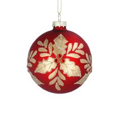 a red and gold christmas ornament hanging on a white background with snowflakes