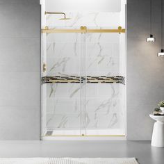 a white and gold bathroom with marble tiles on the shower wall, toiletries and rugs