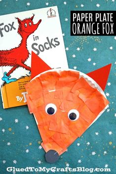 an orange fox paper plate craft with the words in socks on it and a book next to it