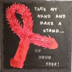 a pink ribbon on a black background that says take my hand and make a stand