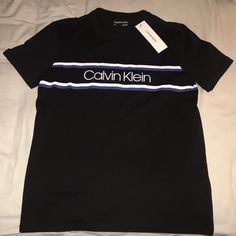 Brand New With Tags Never Worn No Stains No Tears Or Rips No Holes Deadstock Chose Your Size S Or Xl 100% Cotton Color Black What You See In The Pictures Is What You Will Get Fast Shipping 1-3 Days Carefully Packaged Posh Ambassador I Got 5 Star Ratings Well Trusted 100% Authentic I Got 650+ Sales Shop With Confidence Send Reasonable Offers Or They Will Be Rejected Calvin Klein Black T-shirt For Streetwear, Sporty Calvin Klein Tops With Logo Print, Calvin Klein Casual Short Sleeve Shirt, Calvin Klein Black Streetwear T-shirt, Casual Calvin Klein Short Sleeve Shirt, Calvin Klein Sporty Tops With Relaxed Fit, Calvin Klein Black Tops With Letter Print, Black Calvin Klein Crew Neck T-shirt, Calvin Klein Black Crew Neck T-shirt