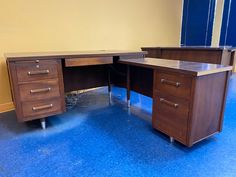 a wooden desk with two drawers on it