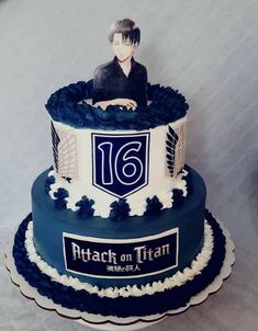 a blue and white cake with a male avatar on it