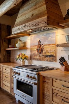 a kitchen with an oven, stove and pictures on the wall above it's cabinets