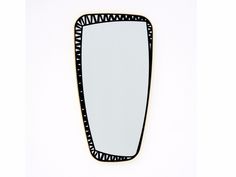 a black and white mirror on the wall with an abstract design around it's edges