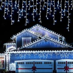 a house with christmas lights hanging from it's roof and decorations on the front