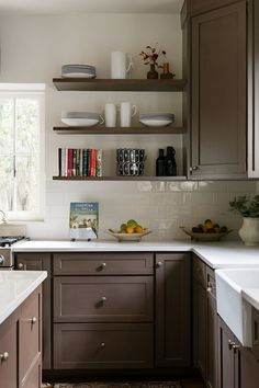 the kitchen is clean and ready for us to use it's shelves are filled with books