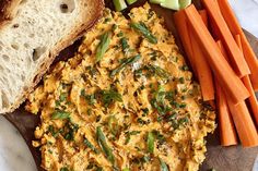 an omelet and carrots on a plate with bread