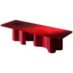 a red table sitting on top of a white floor