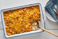 a casserole dish with meat and vegetables in it next to a fork on a plate