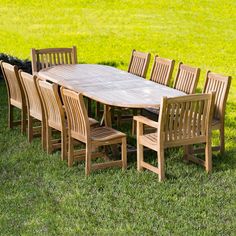 a wooden table and chairs in the grass