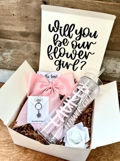 a gift box filled with personalized items and a card that says, will you be our flower girl?