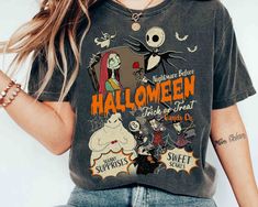 a woman wearing a halloween t - shirt and jeans