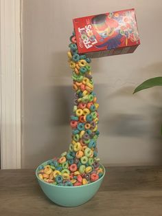 a bowl full of cereal sitting on top of a table next to a box of cereal