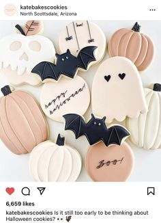 decorated halloween cookies with bats, pumpkins and skulls on them are arranged in a circle