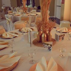 the tables are set with white linens and orange napkins for an elegant wedding reception