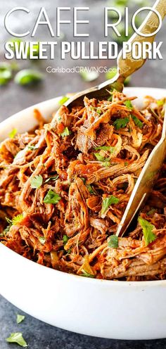 a white bowl filled with pulled pork and garnished with cilantro on the side