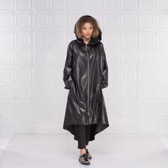 "Black Raincoat Women, Cyberpunk Rain Jacket, Hooded Cape Coat This cyberpunk rain jacket has an asymmetrical design longer on the back and shorter on the front. It has long double side zipper along with two side pockets and long belt to adjust the waistline to your personal needs and fashion style. The elastic finishes on the sleeve and the light fabric make this rain coat a \"must have\" fashion piece for the season. The model in the picture is 168cm. ⅼ 5.6 ft. tall and is wearing size S / col Cyberpunk Rain, Designer Raincoats, Steampunk Coat, White Summer Shirt, Black Raincoat, Oversized White Shirt, Urban Apparel, Rain Cape, Raincoat Jacket