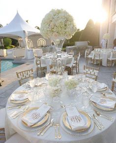 an image of a table set up for a wedding reception with white and gold decorations