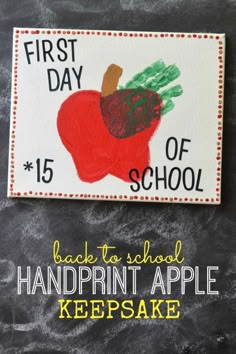 an apple handprinted with the first day of school on it