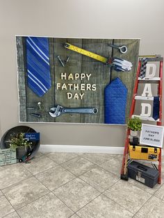 a father's day display with tools and signs on the wall next to a ladder