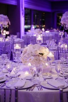 an image of a table set up for a wedding with candles and flowers on it