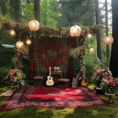 a stage set up with guitars, lights and flowers on the ground in front of it