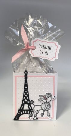 a thank card with the eiffel tower on it, and a pink ribbon