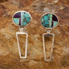 These gorgeous Sterling Silver Earrings, as part of the Shalako collection, feature Sugilite, Blue Campitos Turquoise, and Lab Opal. Dimensions: 1/2"W x 1 1/4"L They are designed by David Rosales, one of the finest contemporary Southwest Artists in the world. He is the founder and co-owner of Supersmiths, Inc. of Gallup, NM. Each pair of these Handcrafted Earrings are custom made and carry a lifetime guarantee. Blue Multi-stone Earrings For Jewelry Making, Blue Multi-stone Sterling Silver Earrings, Purple Multi-stone Sterling Silver Earrings, Sterling Silver Dangle Earrings With Inlay, Unique Multi-stone Round Earrings, Inlay Drop Earrings Jewelry Gift, Drop Earrings With Inlay As Gift, Sterling Silver Inlay Drop Earrings, Sterling Silver Drop Earrings With Inlay