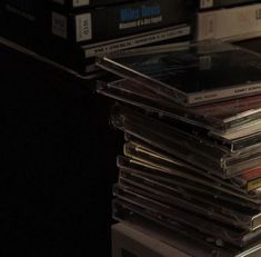 a stack of cd's sitting on top of a table next to each other